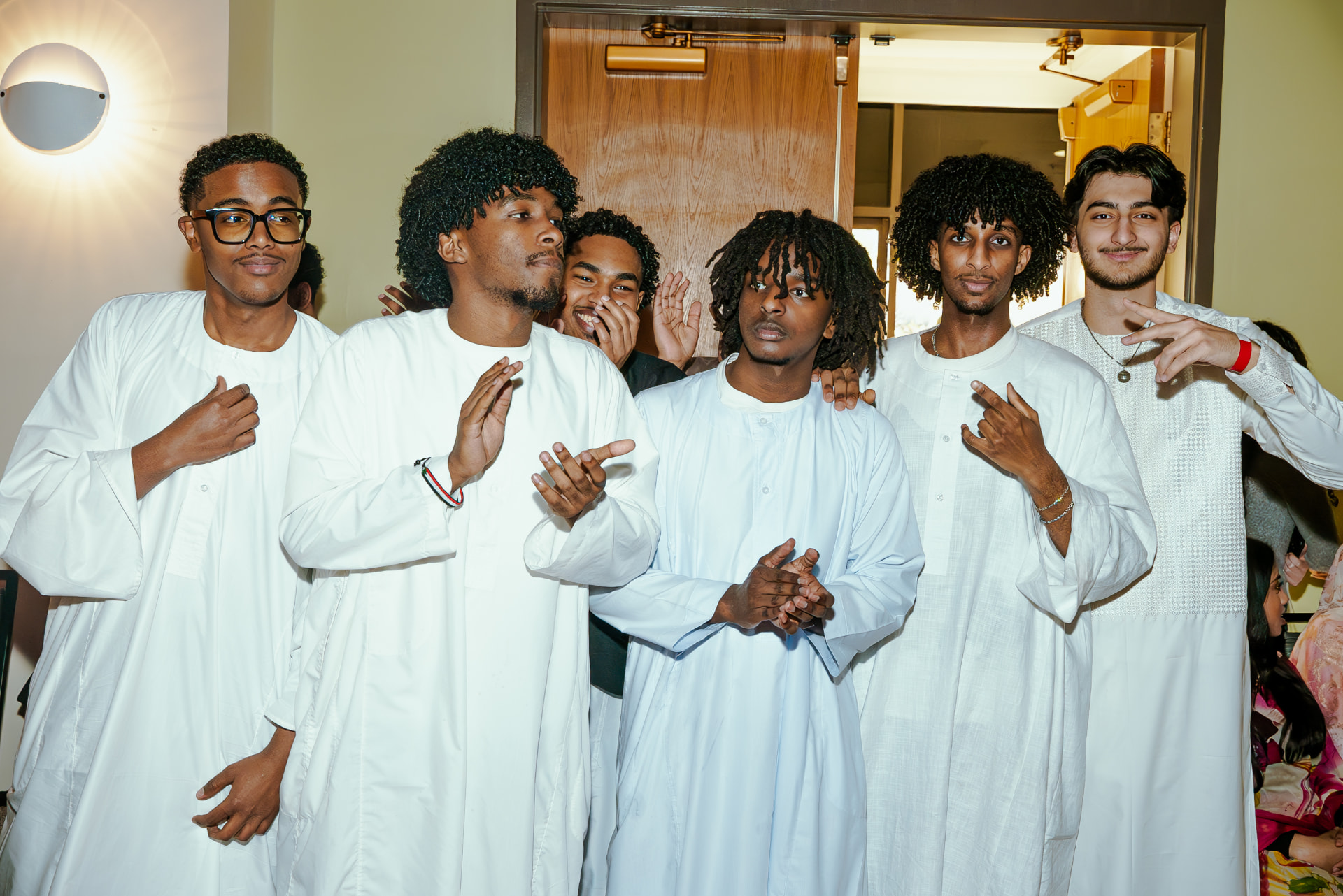 Group of students in white jalabiyas posing at Taste of Sudan